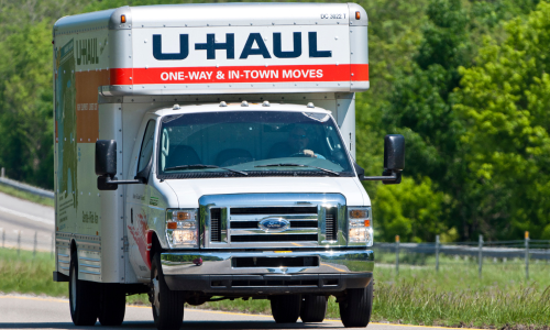 U-Haul truck driving on the road on a clear day